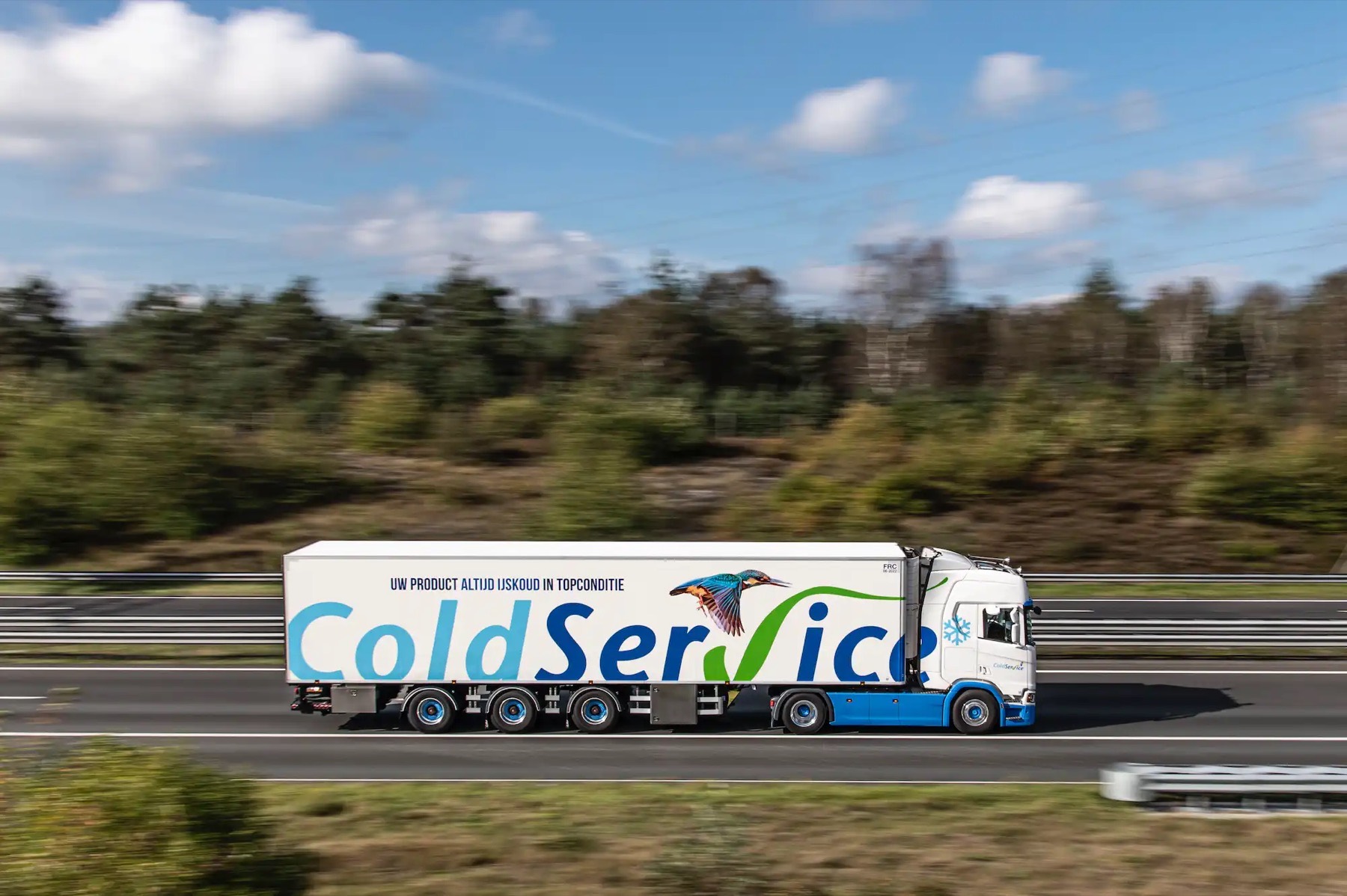 Refrigerated Coldservice trailer on the motorway under a blue sky