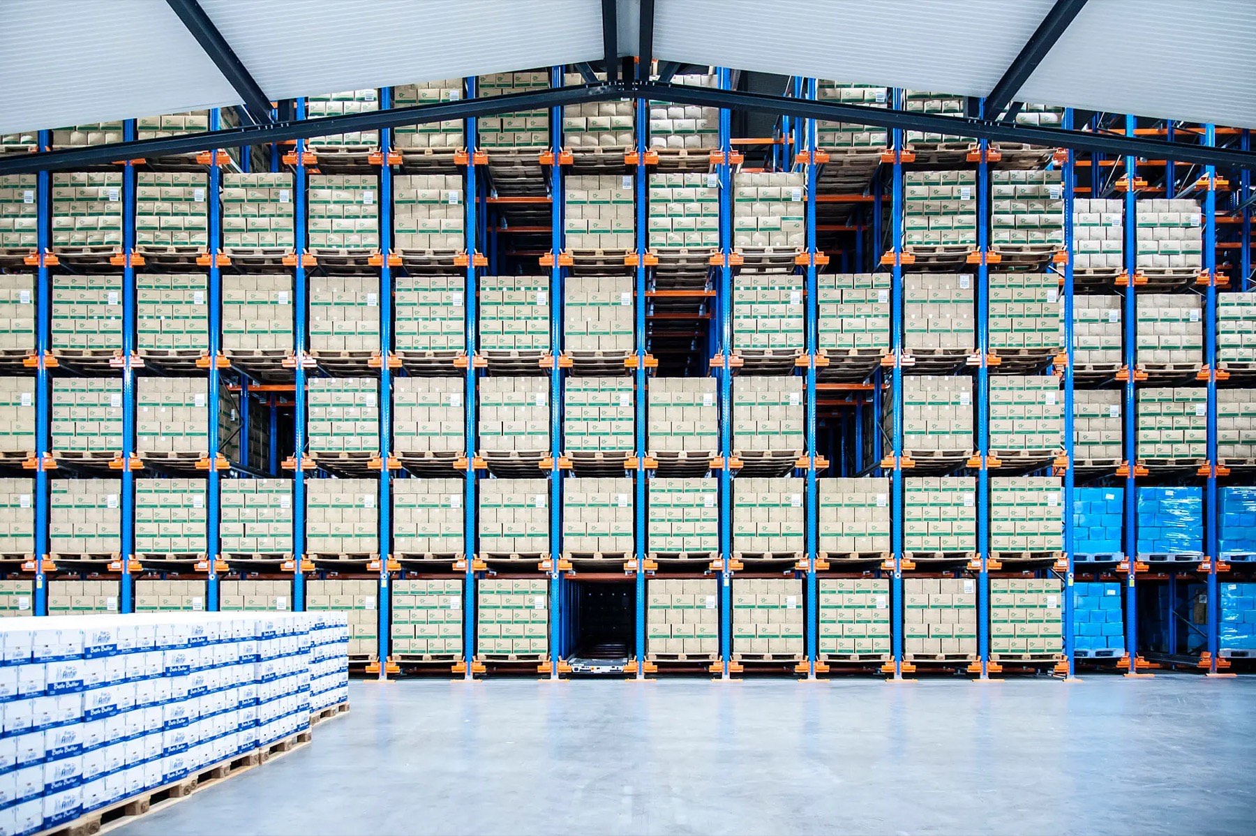 Tall blue racking full of palletised boxes in the Coldservice cold store in Veghel